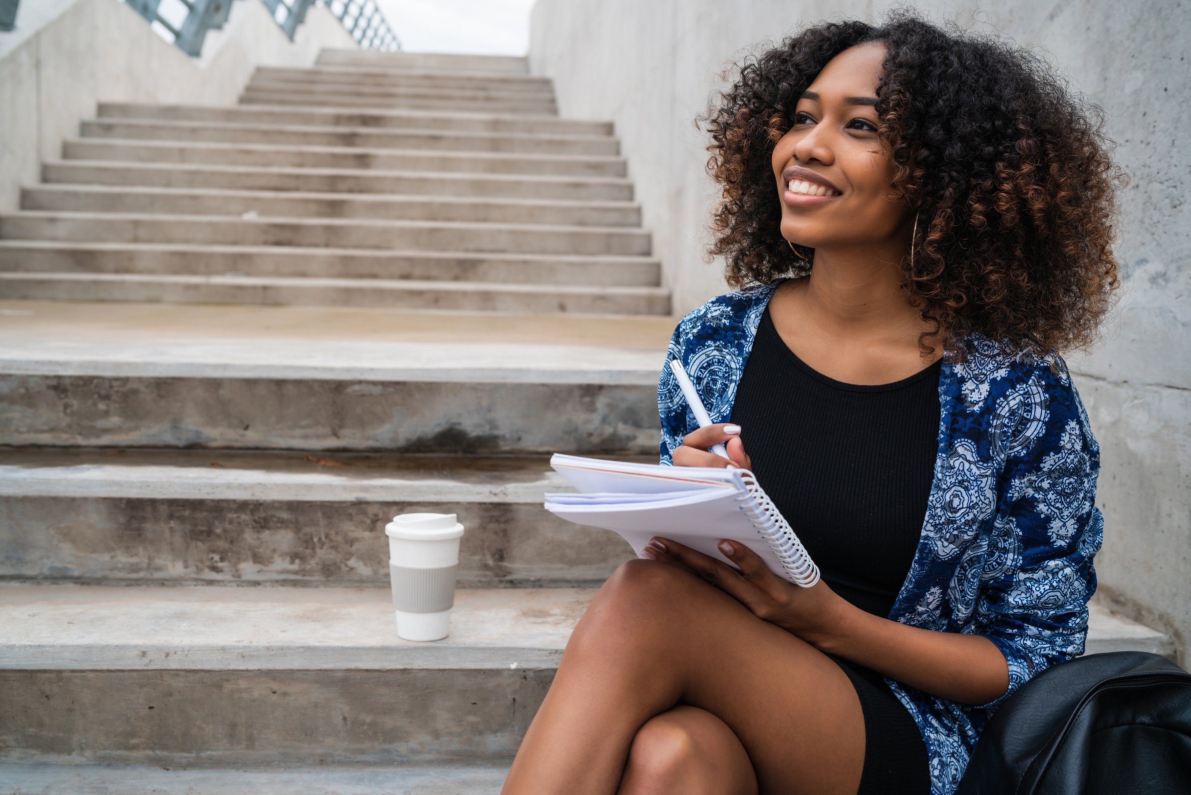 Afro-american women writing in notebook.